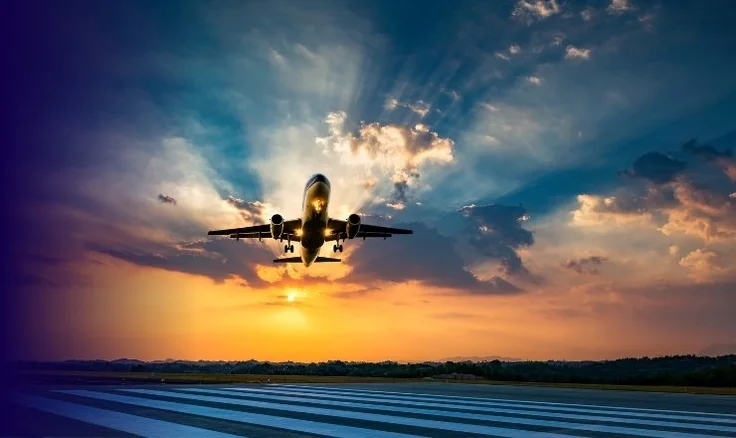 plane taking off in sunset