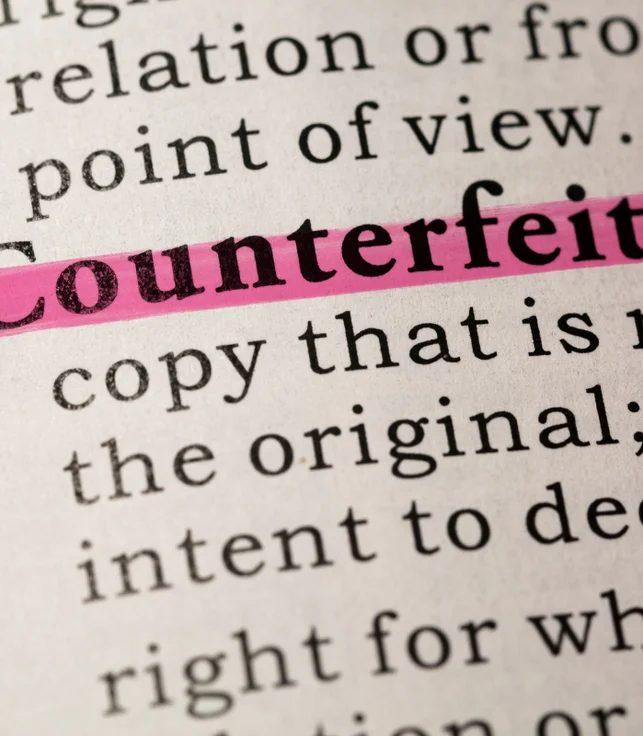 "counterfeit" word highlighted in a book