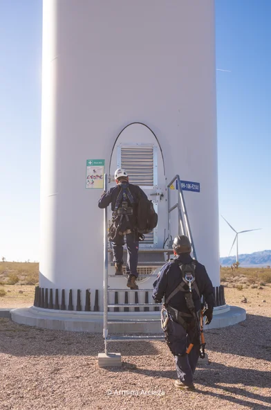 Mersen wind generator maintenance team entering a wind tower